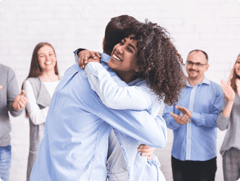 diverse-people-hugging-after-successful-workshop-o-YTH7XPS-1