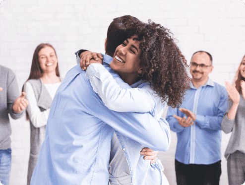 diverse-people-hugging-after-successful-workshop-o-YTH7XPS-1 diverse-people-hugging-after-successful-workshop-o-YTH7XPS-1