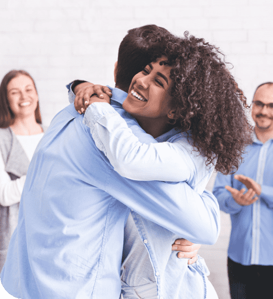 diverse-people-hugging-after-successful-workshop-o-YTH7XPS