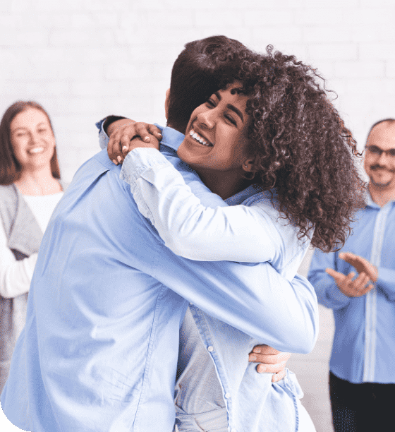 diverse-people-hugging-after-successful-workshop-o-YTH7XPS diverse-people-hugging-after-successful-workshop-o-YTH7XPS