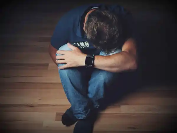 depressed man sitting on the floor