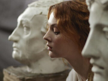 sad woman between two statues of men